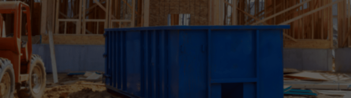 Blur dumpster, recycle waste and garbage bins near new construction site of appartment houses building